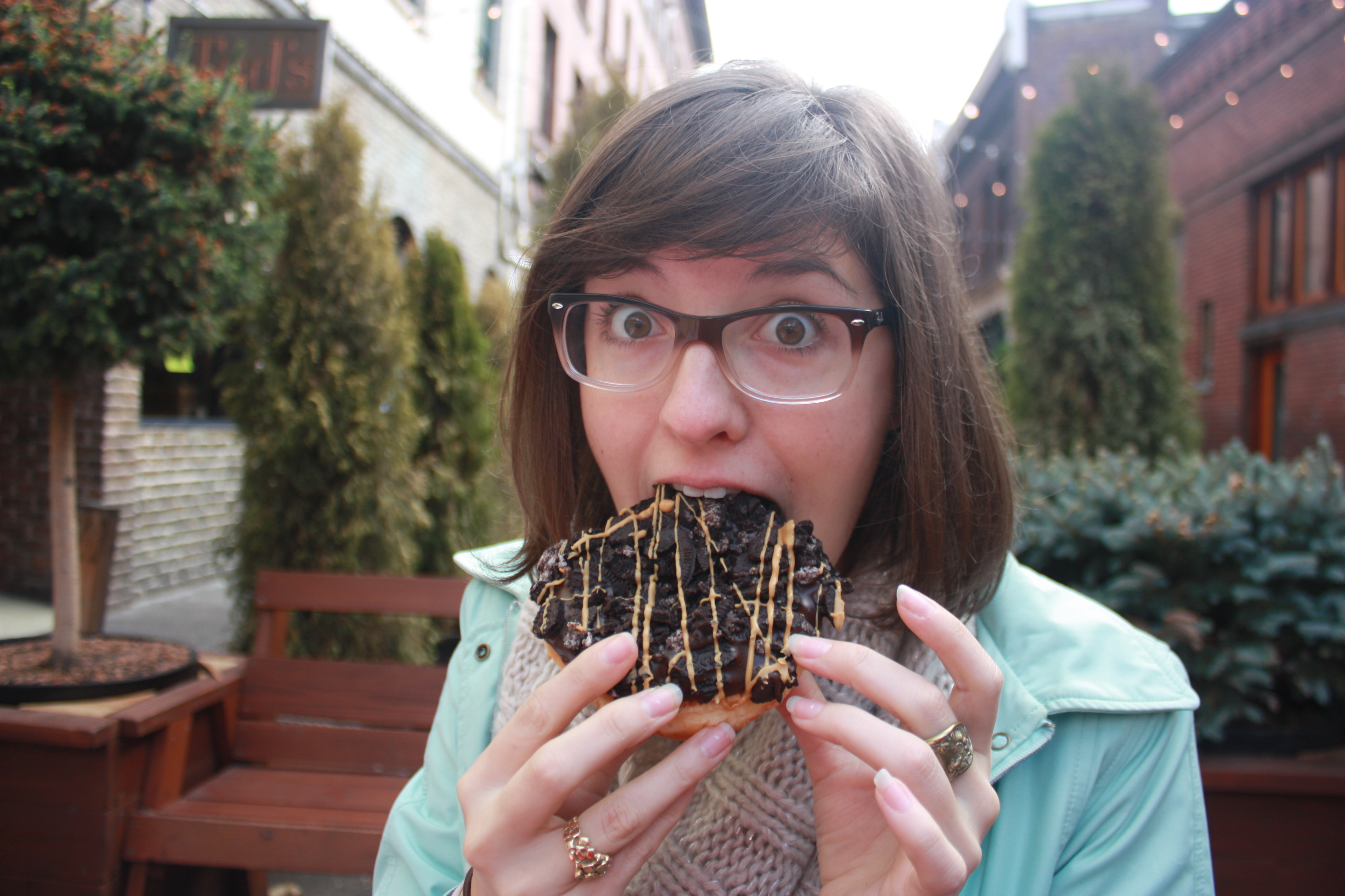Young Woman Eating Oreo Chocolate Donut Voodoo Donuts Portland Oregon